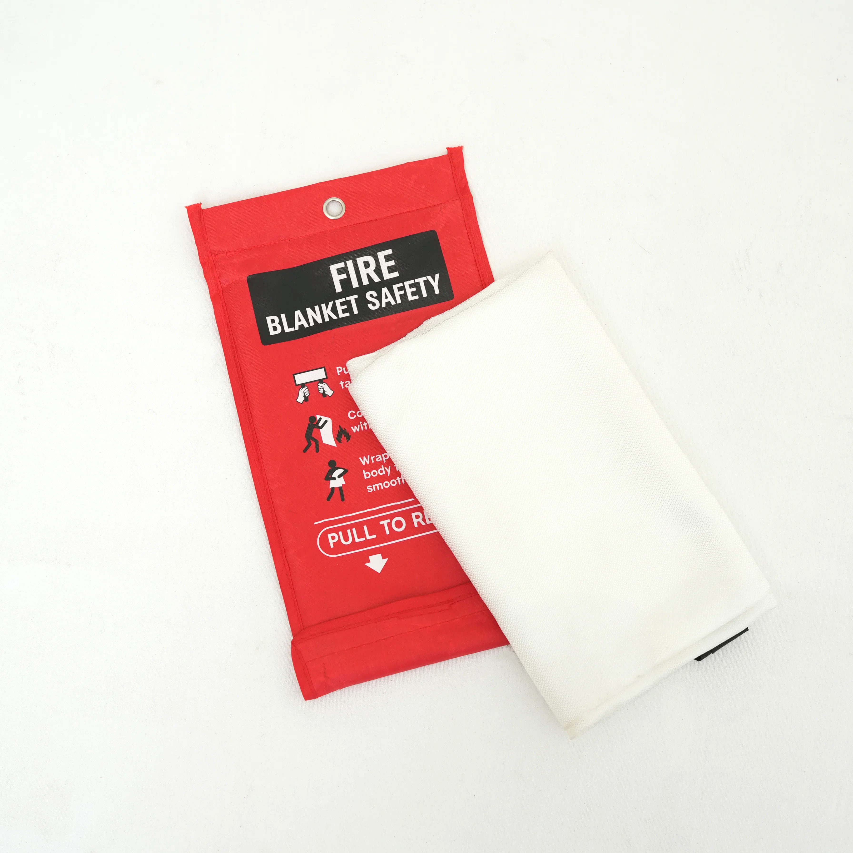 Hands holding up a traditional fire blanket ready for deployment on white background