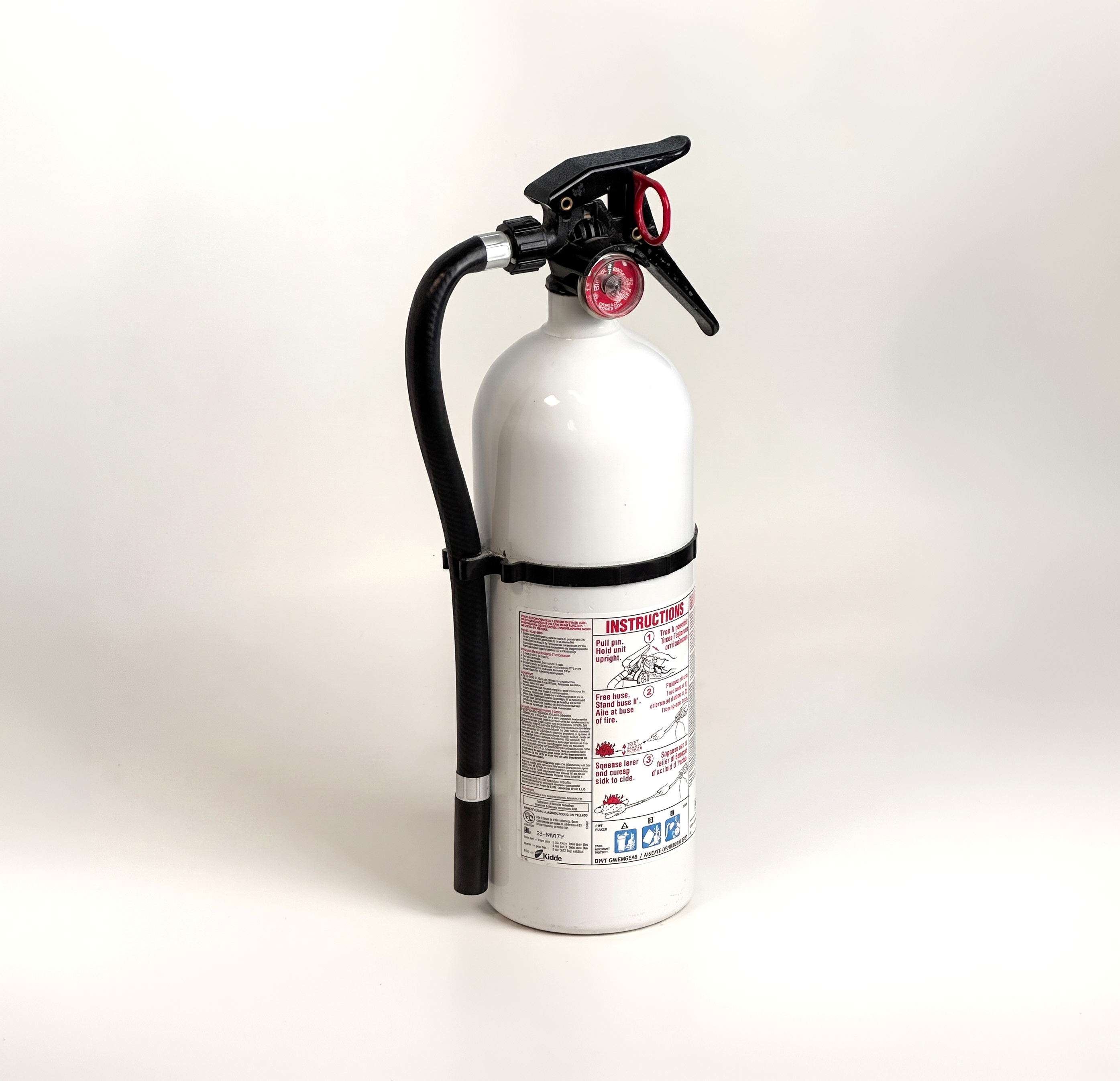 Person holding a red fire extinguisher on a light background